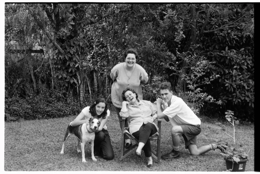 a family group with a dog in a garden, film