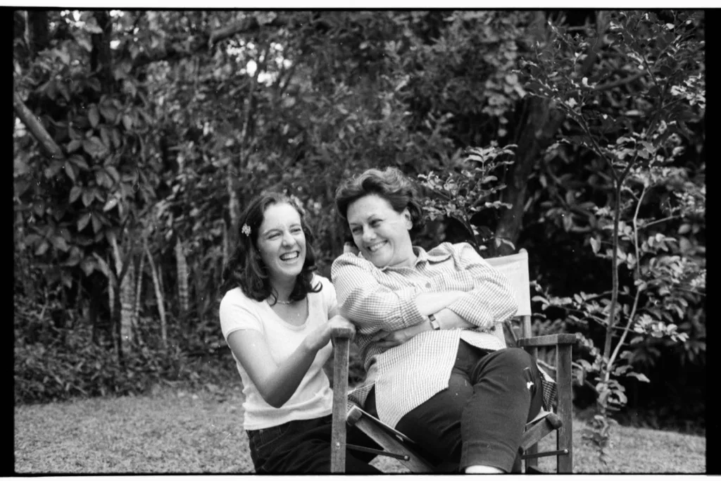 two people laughing in a garden, black and white film