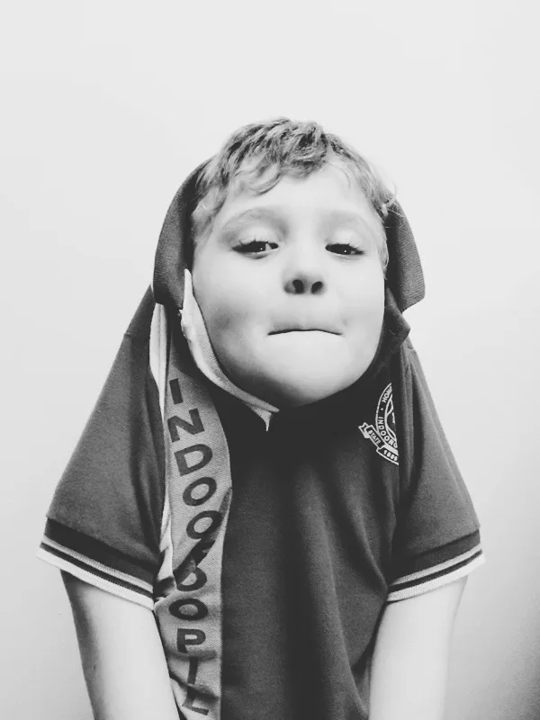 Portrait of a boy with shirt over his head